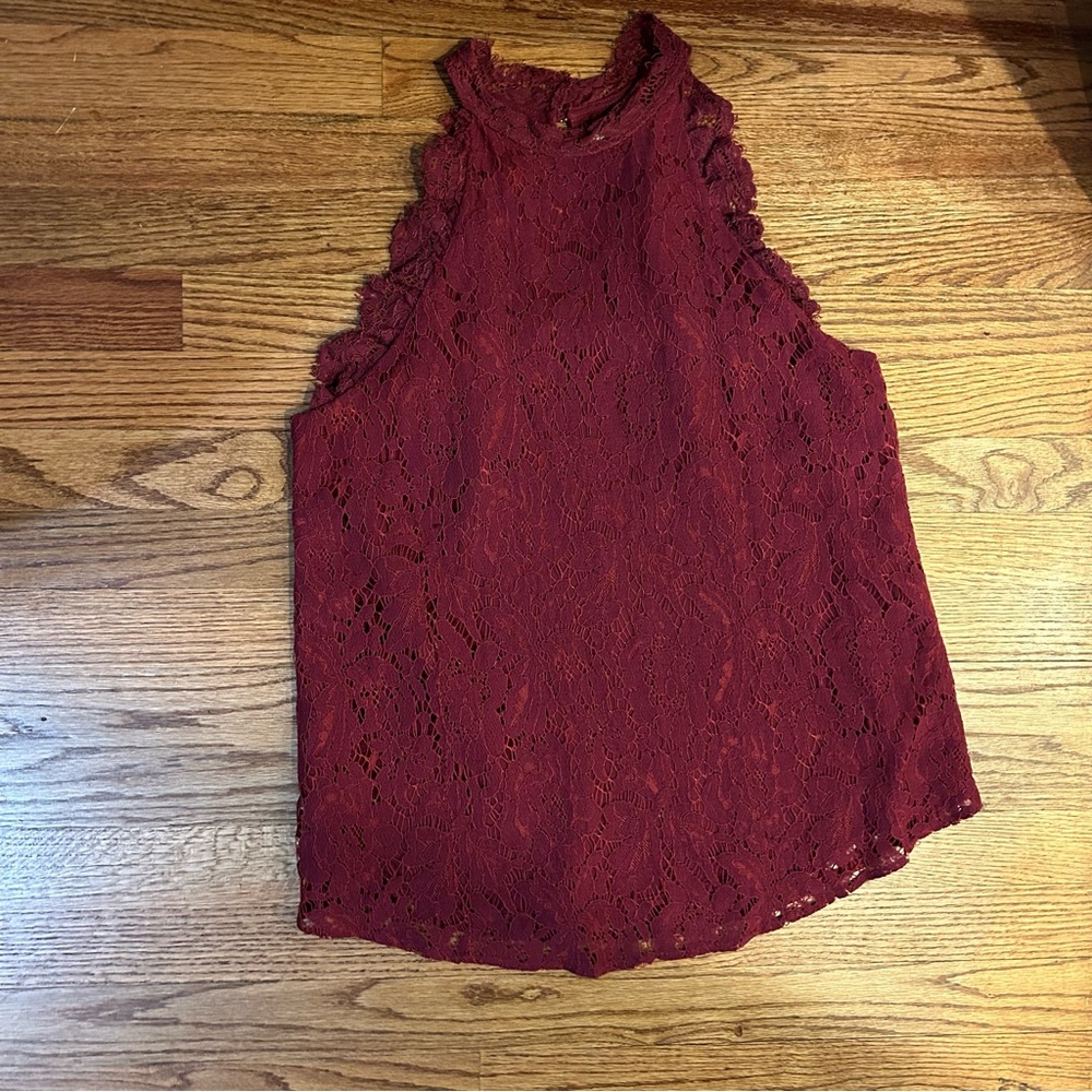 Cranberry sleeveless lacy top. Fully lined. One button in back.